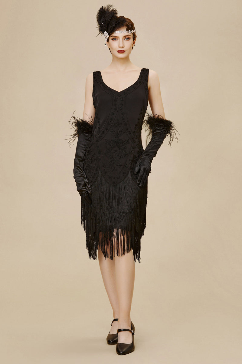 a woman dressed in a vintage red sleeveless Cocktail Party outfit with a tasseled hem