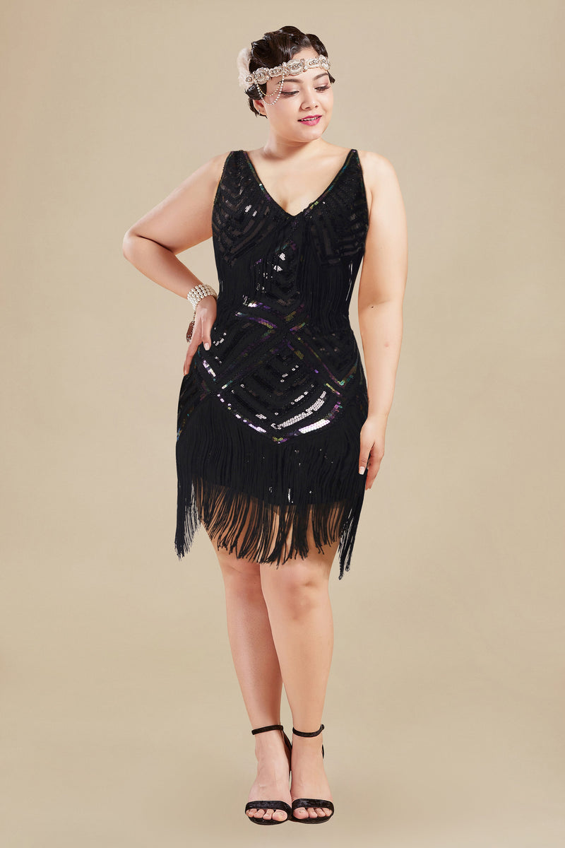a woman wearing a plus-size black dress with zigzag-hem tassels