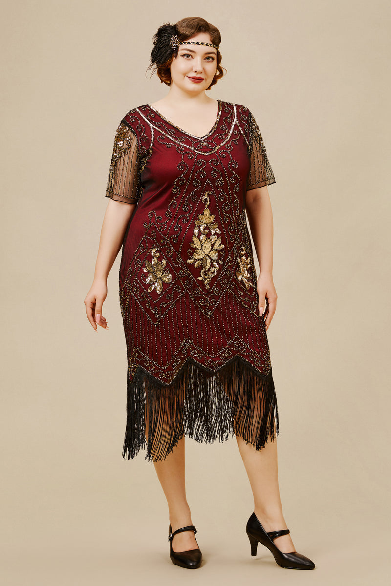 woman wearing a plus size red-gold-and-black flapper dress in deco art style with beads and sequins in geometric shapes, floral patterns and irregular tasseled hemline