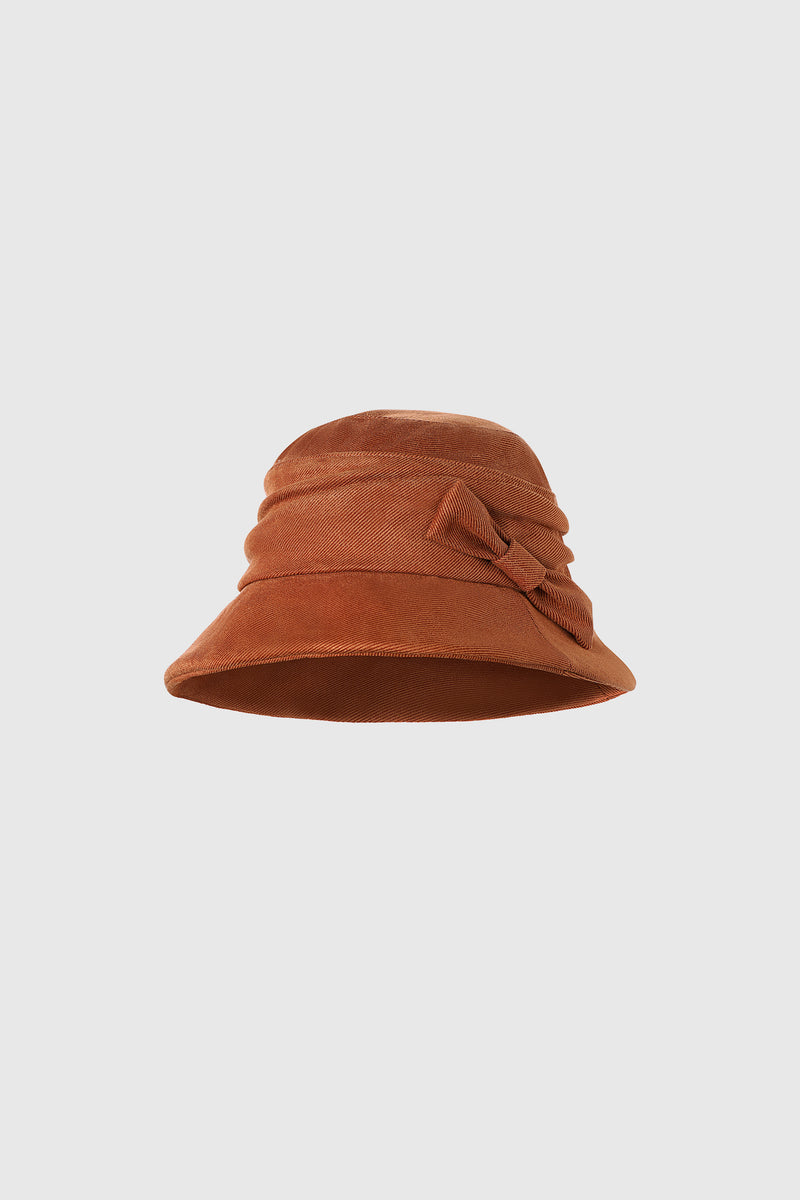 a Bow-Trimmed, Wide-Brimmed tan Bucket Hat or cloche