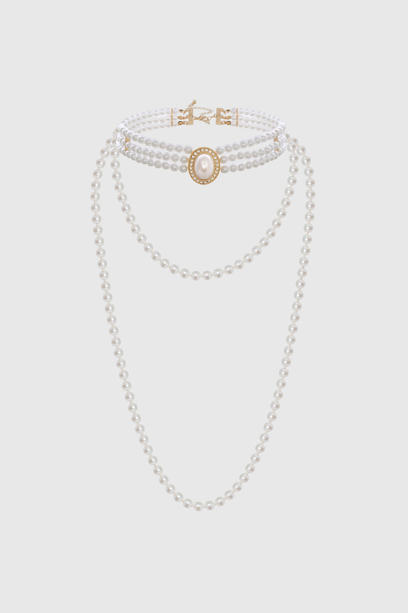 a three-strand pearl necklace set with a choker and pink accents