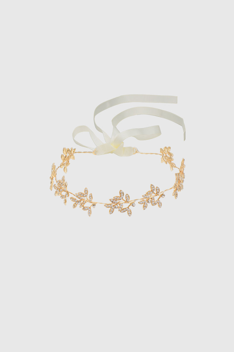 a glittery headband with crystal-studded vine design and white adjustable ribbon